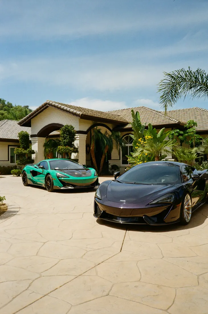 Teal and black McLarens in a driveway after a mobile detail in North County